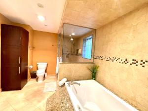 Vihome516C1-Deluxe Double Bedroom near Bayview في تورونتو: حمام كبير مع حوض استحمام ومرحاض