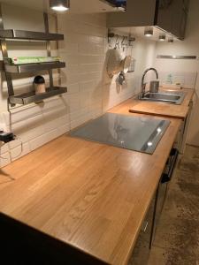 a kitchen with a wooden counter top with a sink at Design loft in Saint-Denis