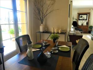 a dining room with a table with chairs and a dining room at Maison Morin in Aups