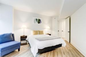 sypialnia z łóżkiem i niebieskim krzesłem w obiekcie 2BR Executive Apartment with Spacious Layout w mieście Arlington