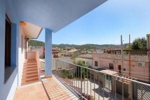 a balcony with a view of a city at CASA AZZURRA - BLUE HOUSE in Teulada
