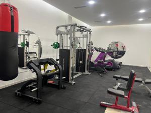 a gym with several tread machines in a room at Lara Hotel in Duhok