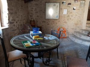 Habitación con mesa de cristal, sillas y bañera. en Molí d'en Pi, en Morella