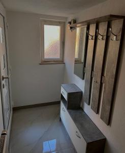 a bathroom with a sink and a mirror and a window at Zwei Zimmer Wohnung mit Küche in Kuchen