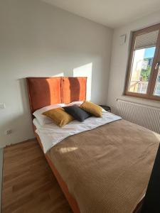 a bedroom with a bed with two pillows on it at Tutu Kraków Comfort in Krakow