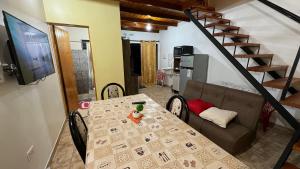 a dining table and a couch in a living room at Adhara Apart in Puerto Iguazú