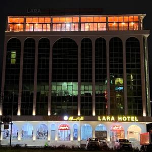 a large building with a lax hotel at night at Lara Hotel in Duhok