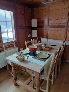 a dining room table with a pot on it at The Raven B&B in Ayer