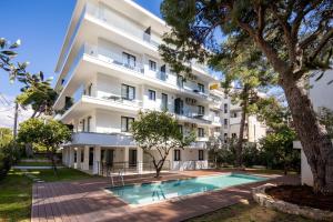 un apartamento con piscina frente a un edificio en Athens Sea Side Escape en Vari