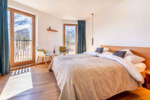 a bedroom with a large bed and a balcony at B & B Longhin in Maloja