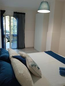 Un dormitorio con una cama grande con almohadas. en villa Amelie, en Fondachello
