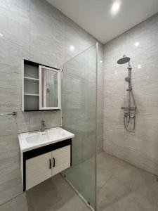 a bathroom with a sink and a shower at Akara Villa Jimbaran in Jimbaran