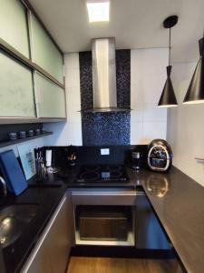 a kitchen with a stove and a sink at Studio centro (Passeio Público) in Curitiba +32 photos