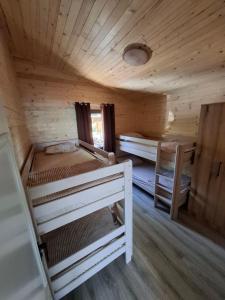 a room with two bunk beds in a cabin at Kucica Una in Ulcinj