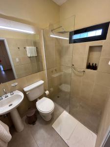 a bathroom with a shower and a toilet and a sink at Casa Rondinella de Bodega Masi in Tupungato