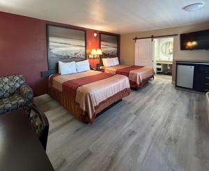 a hotel room with two beds and a flat screen tv at Motel 6 Pasadena, CA Old Town Pasadena Area in Pasadena