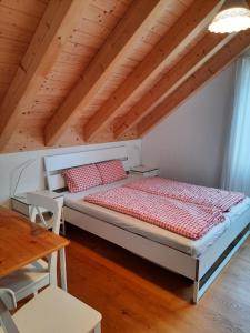 a bed in a room with a wooden ceiling at Chalet-Stil privat Zimmer 1-4 in Engelberg