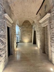 a hallway in a castle with a brick wall at Case Pacifici in città in Ascoli Piceno
