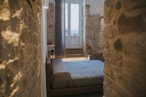 a bedroom with a bed in a room with a window at Blu Marina Apartment in Giovinazzo