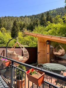 a balcony with two baskets and a table and chairs at Hotel Borjomi Verde in Borjomi
