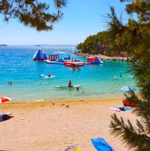 a group of people in the water at a beach at Mobile Home SkyLine - beautiful sea view - on the palm of the beach in Drage