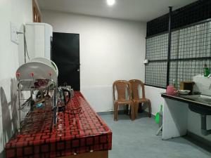 a kitchen with a sewing machine sitting on a table at The Serene Cottage in Viripara