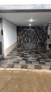 an empty room with a checkered tile floor at Casa Bela Vista da Serra da canastra in São Roque de Minas