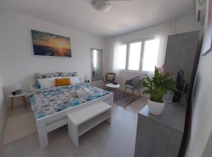 a bedroom with a bed and a living room at Studio M in Pula