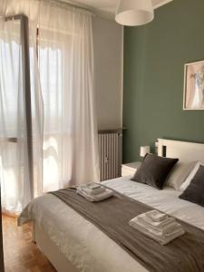 a bedroom with a bed with two towels on it at [Elce-Perugia] Brightest Condo 1 Km From The CityCenter in Perugia