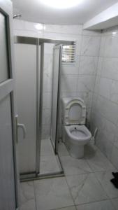 a bathroom with a toilet with a shower stall at NOBIS Cihangir Apartments in Istanbul