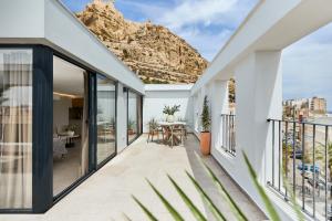 a balcony of a house with a mountain in the background at El Pont Alicante Apartments in Alicante