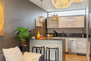 a kitchen with a counter and two bar stools at Loma Verde Aparthotel in Medellín