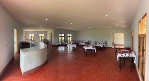 a large room with tables and chairs in a building at Manyara Exclusive Safari Lodge in Mto wa Mbu