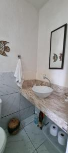 a bathroom with a sink and a toilet at Pelados Beach Hostel in Pipa