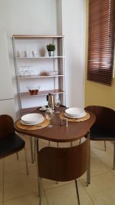 a dining room table with two plates and wine glasses at Piso Arrecife Centro in Arrecife