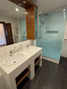 a bathroom with two sinks and a glass shower at Villa Samac in Trogir +159 photos