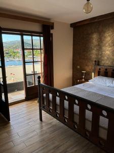 a bedroom with a large bed and a large window at Villa Samac in Trogir