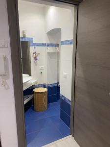 a bathroom with a blue tiled floor and a shower at Casa Sole E Luna in Genoa +36 photos