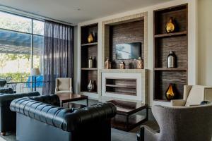 a living room with a couch and a fireplace at Hampton Inn By Hilton Celaya in Celaya