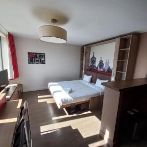 - une chambre avec un lit et un bureau dans l'établissement City'O apparthotel, à Caen