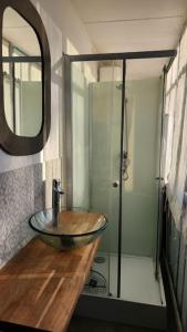 a bathroom with a glass sink and a shower at Artiste in Douai