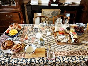 a table with a plate of food on it at Maison Beurdelaine in Avallon