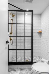 a bathroom with a shower with a toilet at Historic Hotel, King Bed, Market Square View, Room # 201 in Bangor