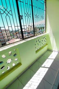 a balcony with a window with a view of a city at Mombasa bamburi staycation 2 in Mombasa
