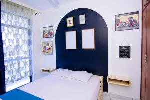 a bedroom with a bed and a blue wall at Mombasa bamburi staycation 2 in Mombasa