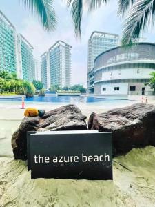 a sign on the beach in front of the zire beach at The Bahamas & Maldives Suites at Azure Residences near Manila Airport in Manila