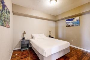 a bedroom with a large white bed and a night stand at The Whale Main and Lower in Lincoln City +47 photos