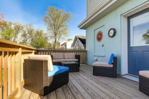 a patio with wicker chairs and a couch on a deck at Waterfront Historical District Home Near River in North East