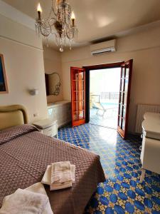 a bedroom with a bed and a sliding glass door at Casa La Scogliera in Praiano