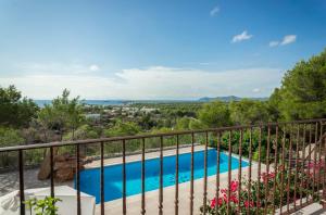 a balcony with a view of a swimming pool at AZUMAR in Santa Eularia des Riu